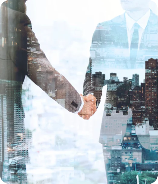 Business handshake overlayed on a city skyline